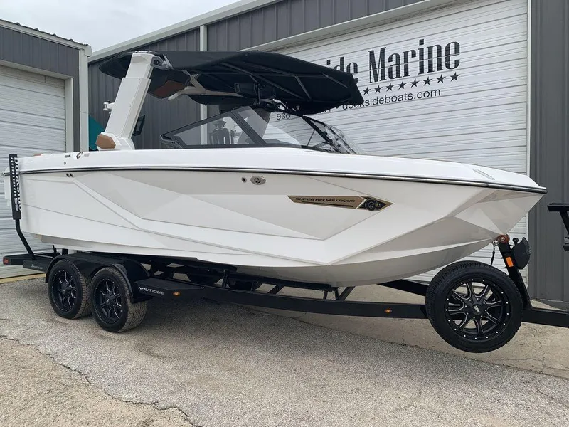 Slide: The Image of 2022 Nautique Super Air Nautique G21 boat on trailer at dockside marina. - 7