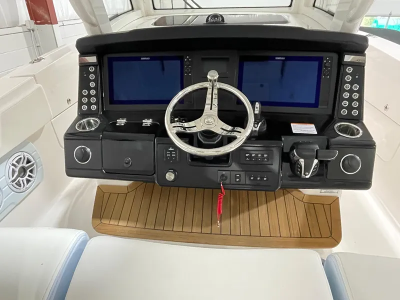 Slide: The Image of 2023 Robalo R360 Center Console helm with dual screens and modern controls. - 2