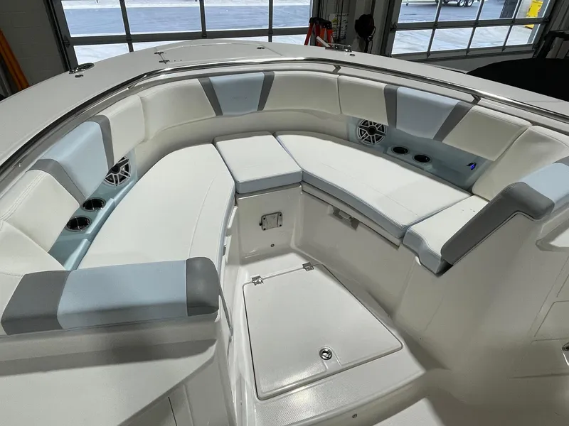 Slide: The Image of 2023 Robalo R360 Center Console boat interior with cushioned seating and storage. - 4