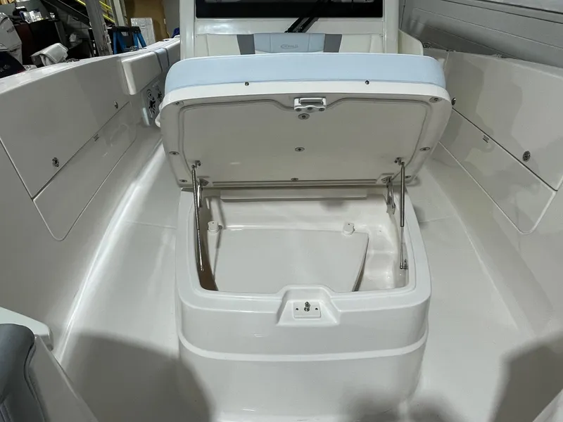 Slide: The Image of 2023 Robalo R360 Center Console boat with open storage compartment. - 6