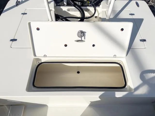 Slide: The Image of 2024 Hewes Redfisher 18 boat storage compartment, open and empty. - 12