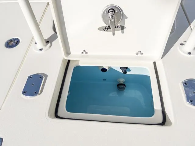 Slide: The Image of 2024 Hewes Redfisher 18 livewell with open hatch, showcasing interior details. - 13