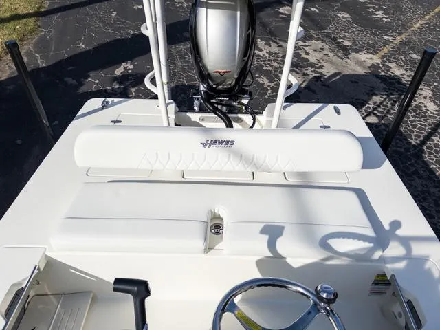 Slide: The Image of 2024 Hewes Redfisher 18 boat interior with steering wheel and motor. - 16