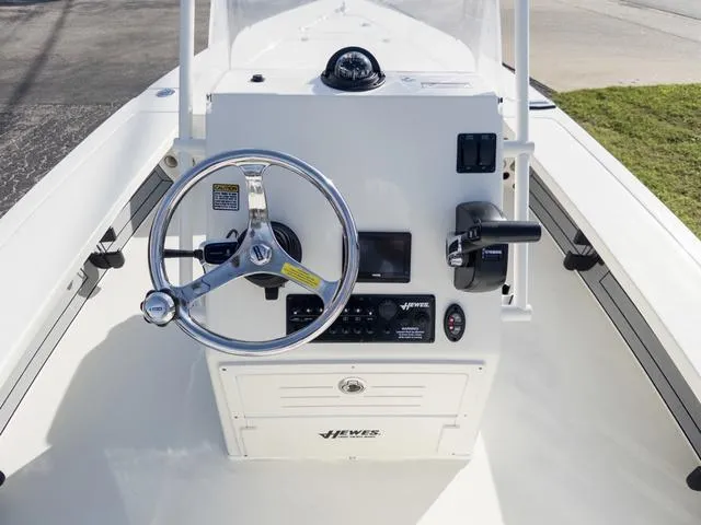 Slide: The Image of 2024 Hewes Redfisher 18 boat console with steering wheel and controls. - 17