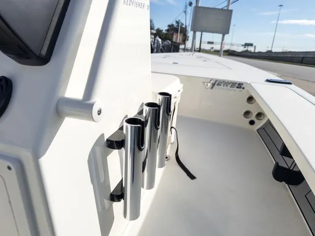 Slide: The Image of 2024 Hewes Redfisher 18 boat with rod holders and sleek design. - 20
