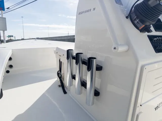 Slide: The Image of 2024 Hewes Redfisher 18 boat interior with rod holders and console details. - 21