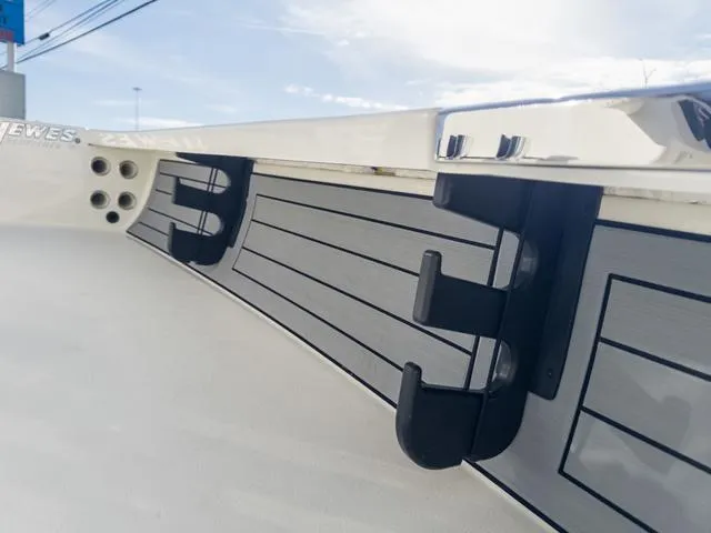 Slide: The Image of 2024 Hewes Redfisher 18 boat detail with sleek design and rod holders. - 23