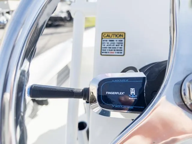 Slide: The Image of Close-up of 2024 Hewes Redfisher 18 boat control lever with FingerFlex feature. - 29