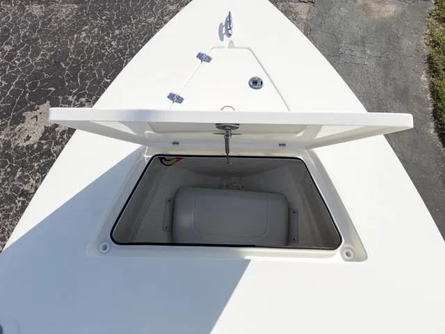 Slide: The Image of 2024 Hewes Redfisher 18 boat storage compartment open on deck. - 33