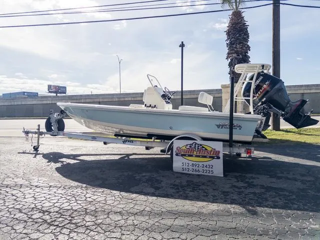Slide: The Image of 2024 Hewes Redfisher 18 boat on trailer, parked outdoors under clear sky. - 36