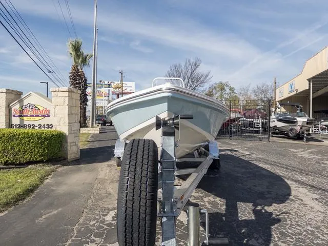 Slide: The Image of 2024 Hewes Redfisher 18 boat on trailer at dealership, sunny day. - 4