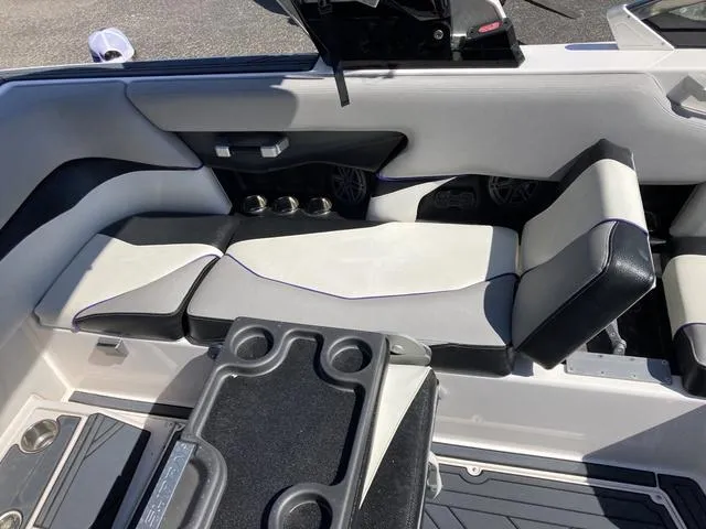 Slide: The Image of 2016 Supra SA 400 boat interior with cushioned seating and cup holders. - 12