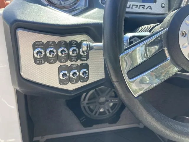 Slide: The Image of Control panel and steering wheel of a 2016 Supra SA 400 boat. - 15