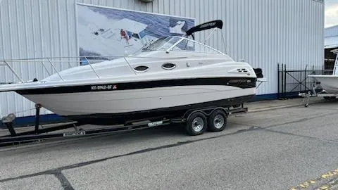 Slide: The Image of 2001 Ebbtide 2500 Mid-Cabin Cruiser on trailer outside a warehouse. - 0