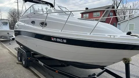 Slide: The Image of 2001 Ebbtide 2500 Mid-Cabin Cruiser on trailer, docked in a residential area. - 2