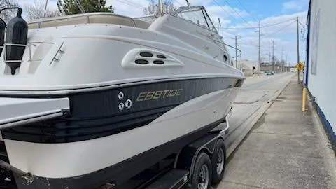 Slide: The Image of 2001 Ebbtide 2500 Mid-Cabin Cruiser on a trailer, parked on a street. - 3
