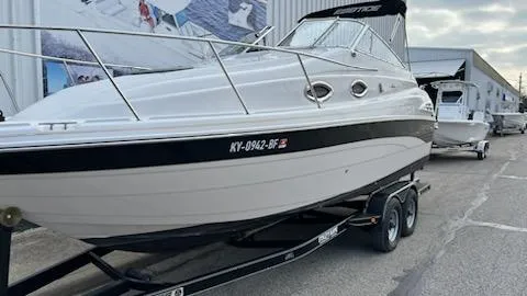 Slide: The Image of 2001 Ebbtide 2500 Mid-Cabin Cruiser on trailer, docked outside a marina. - 6
