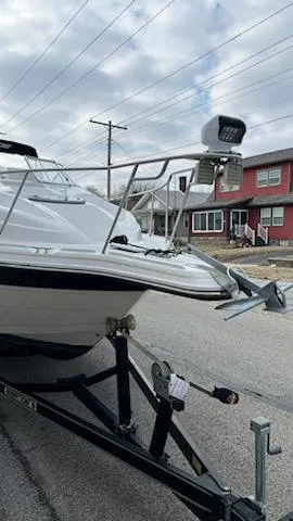 Slide: The Image of 2001 Ebbtide 2500 Mid-Cabin Cruiser on trailer, residential street background. - 7