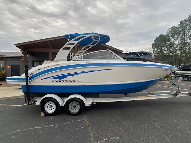 Slide: The Image of 2018 Chaparral 224 Sunesta boat on a trailer, parked outdoors. - 0