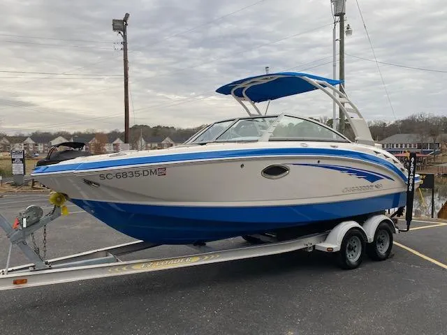 Slide: The Image of 2018 Chaparral 224 Sunesta boat on a trailer with blue and white exterior. - 1