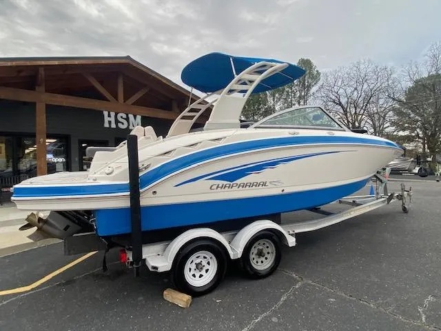 Slide: The Image of 2018 Chaparral 224 Sunesta boat on trailer, parked outside a building. - 13