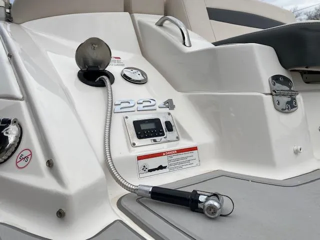 Slide: The Image of 2018 Chaparral 224 Sunesta boat deck with control panel and hose. - 18
