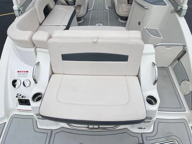 Slide: The Image of 2018 Chaparral 224 Sunesta boat interior with white seating and cup holders. - 21