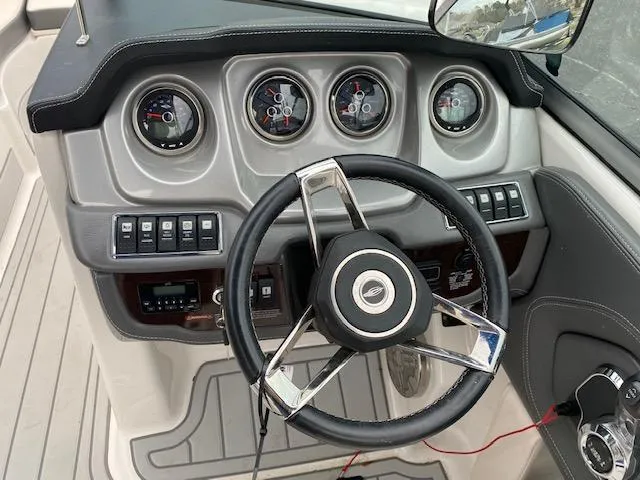 Slide: The Image of 2018 Chaparral 224 Sunesta boat dashboard with steering wheel and gauges. - 22