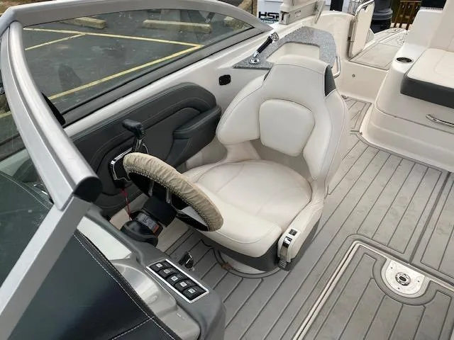 Slide: The Image of 2018 Chaparral 224 Sunesta boat interior with captain's chair and steering wheel. - 28