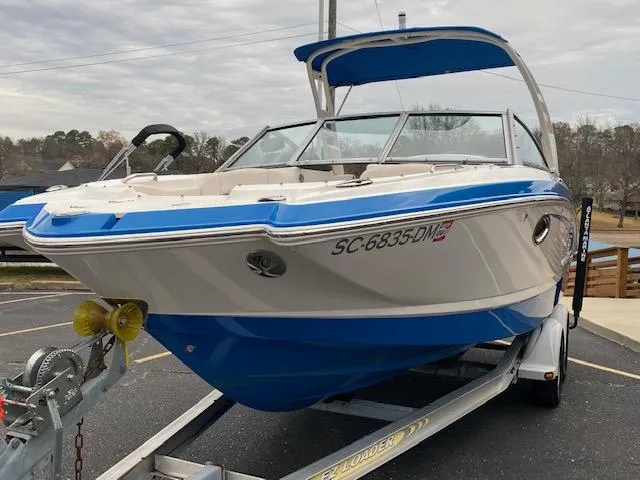 Slide: The Image of 2018 Chaparral 224 Sunesta boat on trailer, blue and white, front view. - 3