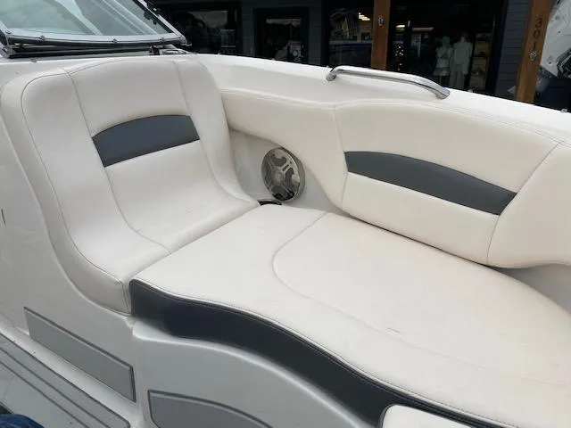 Slide: The Image of 2018 Chaparral 224 Sunesta boat interior seating with white and gray upholstery. - 30