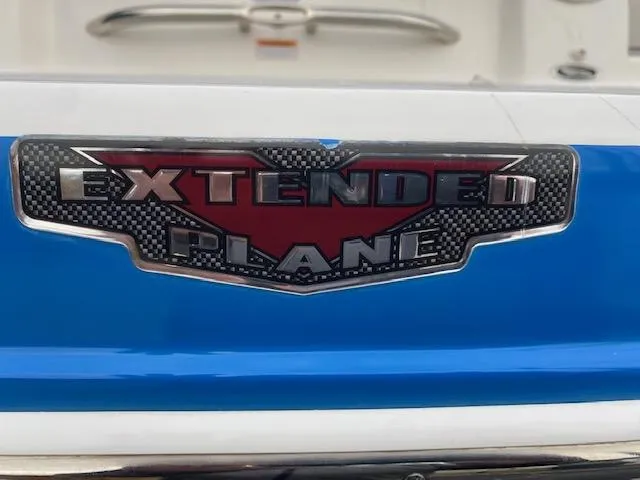 Slide: The Image of 2018 Chaparral 224 Sunesta Extended Plane badge on blue and white boat. - 34