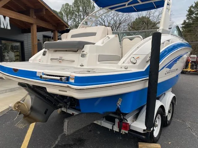 Slide: The Image of 2018 Chaparral 224 Sunesta boat on trailer, blue and white exterior, rear view. - 8