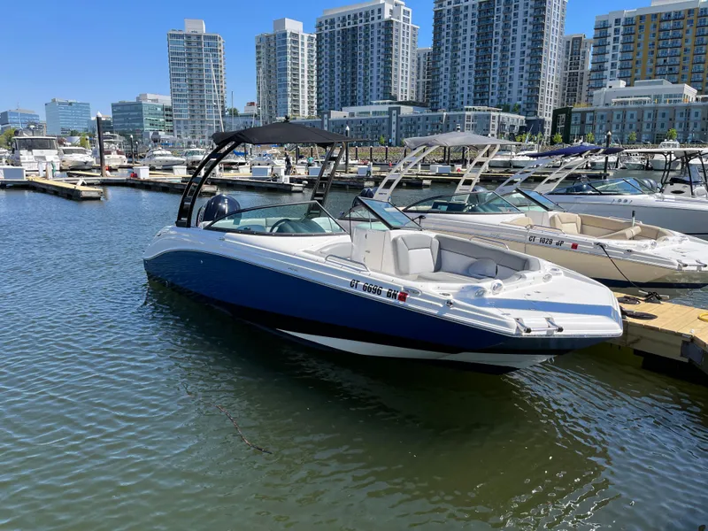 Slide: The Image of 2021 NauticStar 243DC Sport Deck boat docked in urban marina. - 13