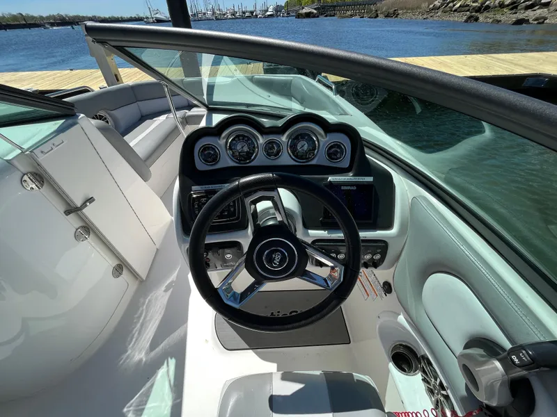 Slide: The Image of 2021 NauticStar 243DC Sport Deck boat interior with steering wheel and dashboard controls. - 18
