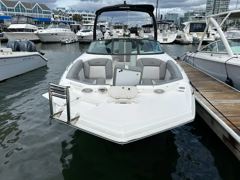 Slide: The Image of 2021 NauticStar 243DC Sport Deck boat docked in a marina. - 21