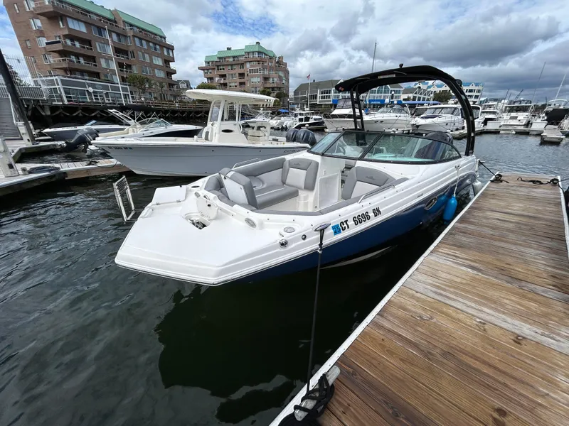 Slide: The Image of 2021 NauticStar 243DC Sport Deck boat docked at marina. - 22