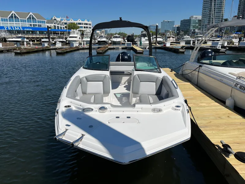 Slide: The Image of 2021 NauticStar 243DC Sport Deck boat docked in a marina. - 25