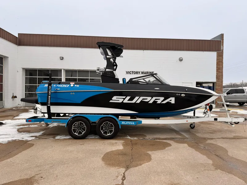The Image of 2021 Supra SR boat in blue and black on a trailer at Victory Marine. - 0