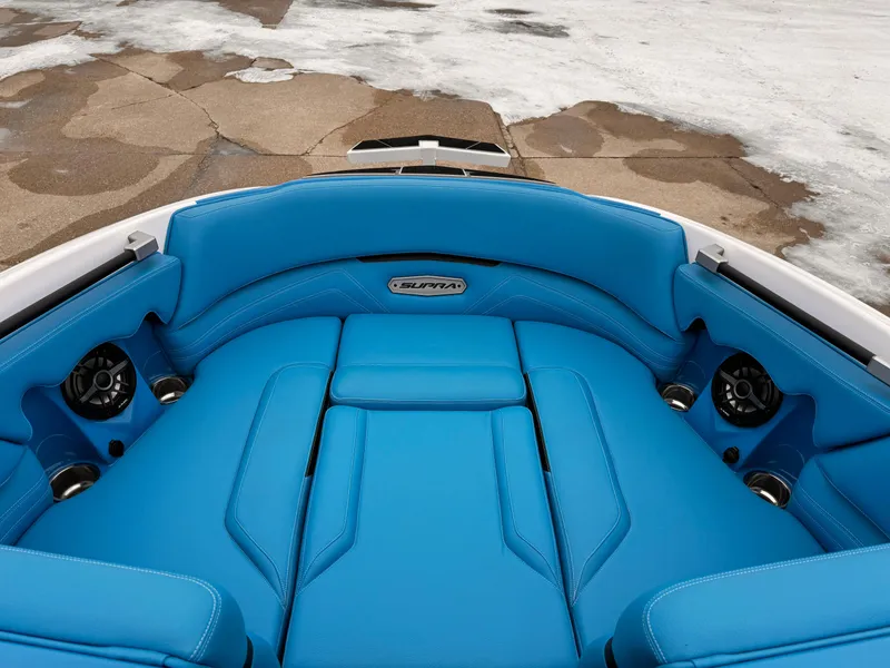 Slide: The Image of 2021 Supra SR boat with blue interior seating and integrated speakers. - 10