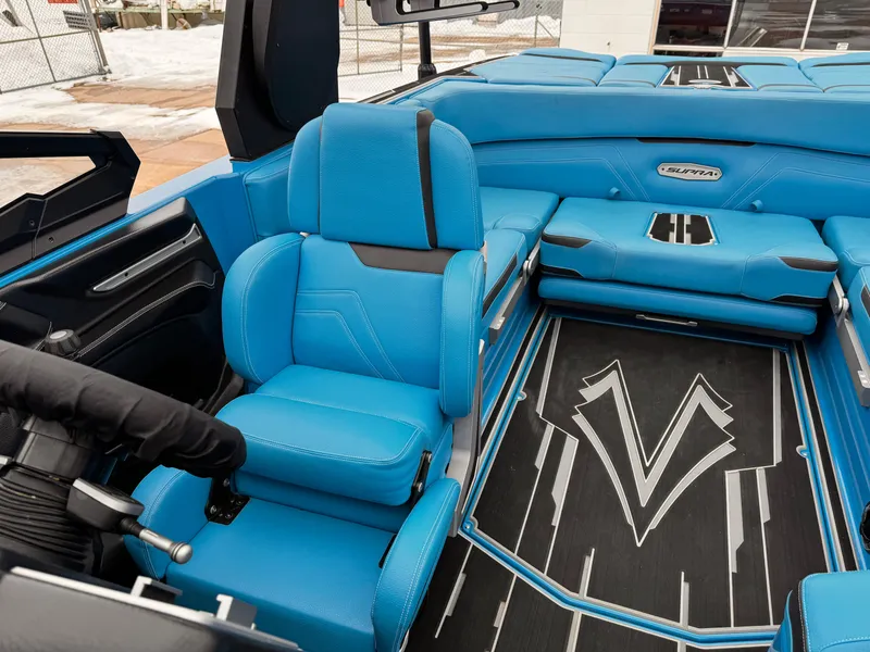 Slide: The Image of 2021 Supra SR boat interior with blue seating and modern design. - 11