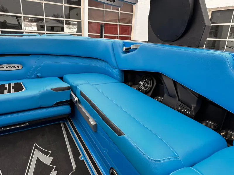 Slide: The Image of 2021 Supra SR boat interior with blue leather seats and modern design. - 13