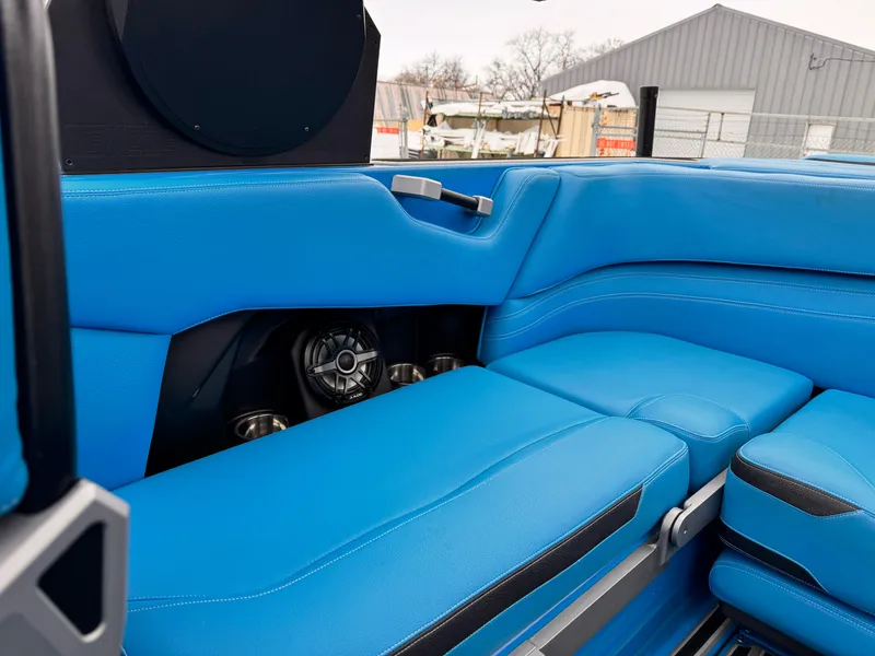Slide: The Image of 2021 Supra SR boat interior with blue leather seats and built-in speakers. - 14