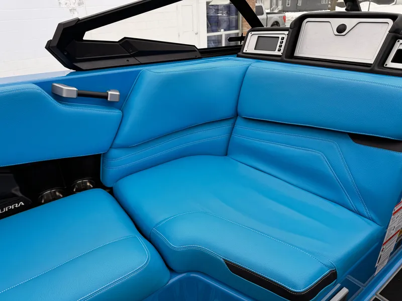 Slide: The Image of 2021 Supra SR boat with blue leather interior and modern dashboard. - 15