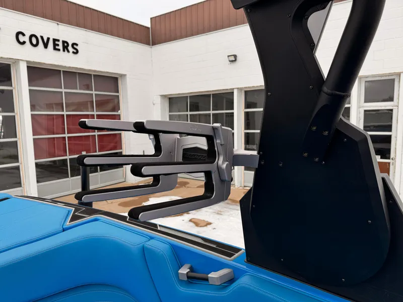 Slide: The Image of 2021 Supra SR boat with blue interior and wakeboard rack. - 16