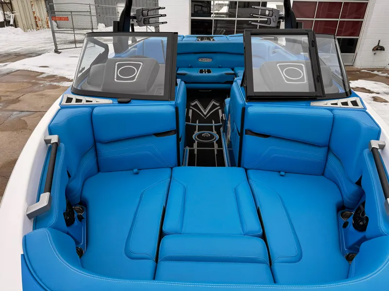 Slide: The Image of 2021 Supra SR boat with blue interior seating and open windshield. - 19