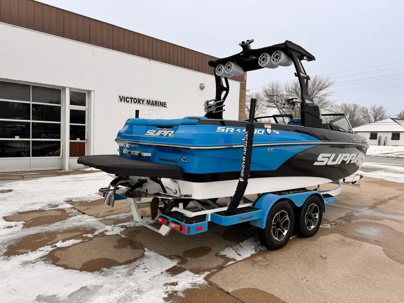 Slide: The Image of 2021 Supra SR boat on trailer at Victory Marine dealership. - 2