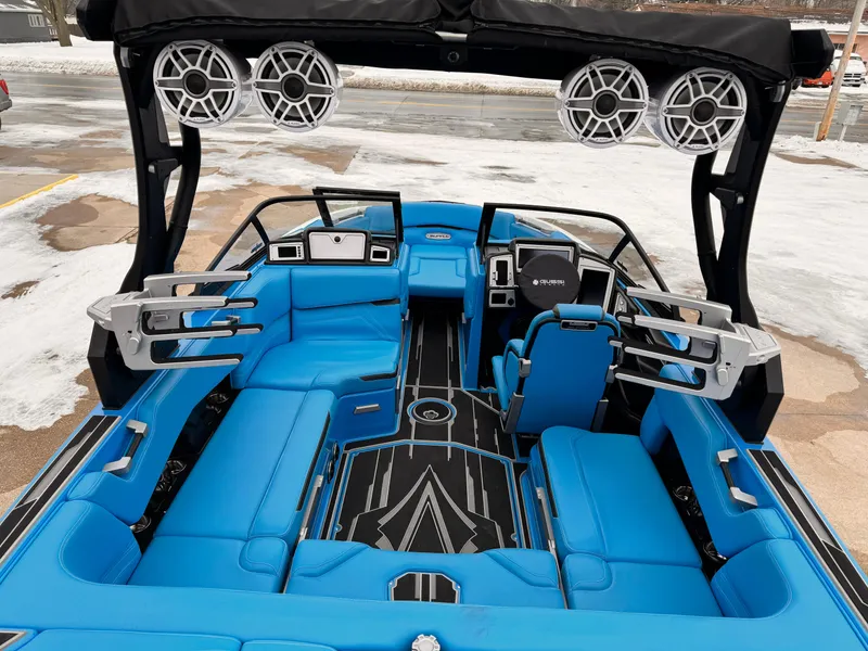 Slide: The Image of 2021 Supra SR boat interior with blue seating and advanced audio system. - 8