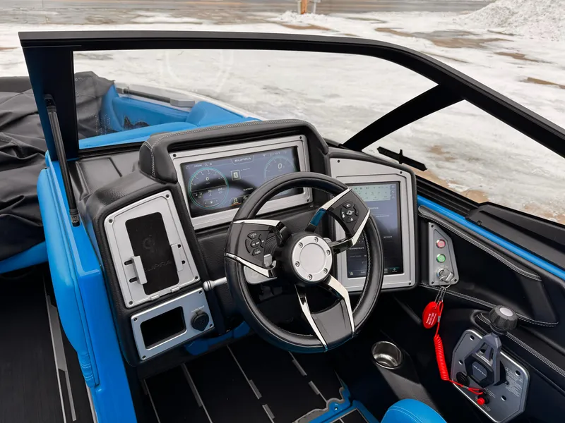 Slide: The Image of 2021 Supra SR boat dashboard with steering wheel and digital displays. - 9