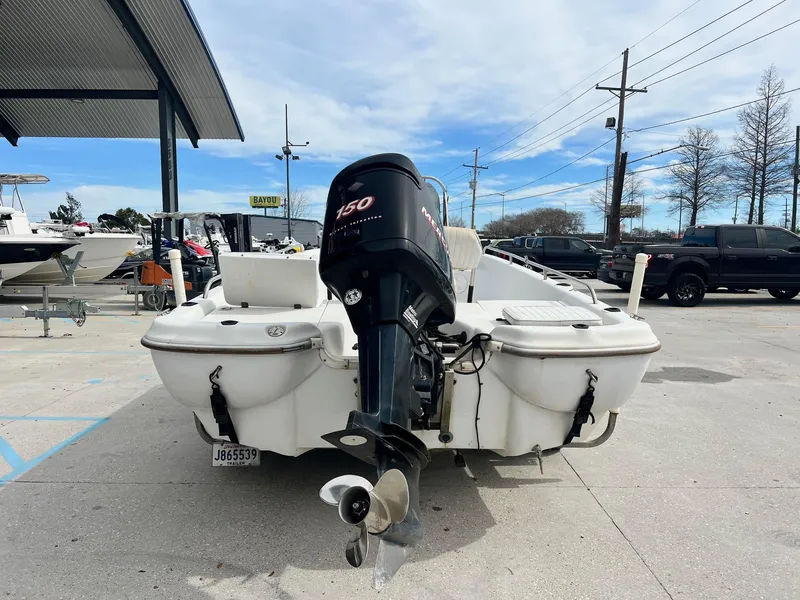 Slide: The Image of 2001 Fishmaster 19 boat with 150 HP outboard motor in a marina. - 2
